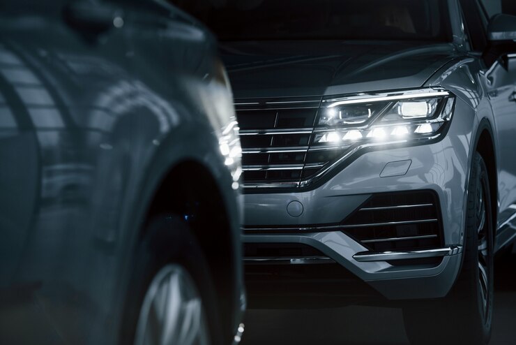 powerful-headlights-particle-view-modern-luxury-cars-parked-indoors-daytime_146671-17395